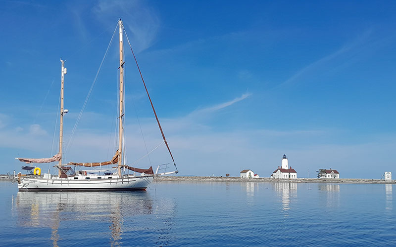 Sailboat with Dungeness Lighthouse in distance